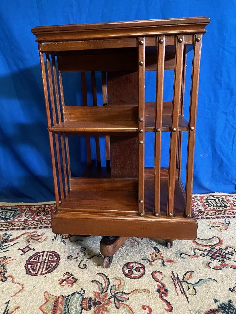 A GOOD QUALITY MAHOGANY REVOLVING BOOKCASE, with slatted sides to