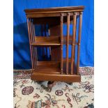 A GOOD QUALITY MAHOGANY REVOLVING BOOKCASE, with slatted sides to