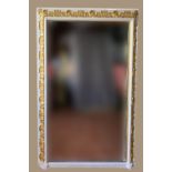 A WHITE & GILT WALL MIRROR, with floral motif, 53 x 67 inches app