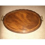 AN EDWARDIAN MAHOGANY OVAL SHAPED TRAY, with raised scalloped gal