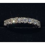 AN 18CT WHITE GOLD 9 STONE HALF ETERNITY DIAMOND RING, the fine r