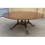 A GOOD QUALITY MAHOGANY CROSSBANDED DINING TABLE, raised four pillar supports on a raised base