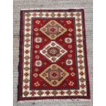 A GOOD QUALITY HANDKNOTTED INDO KAZAK WOOL RUG, with nice vibrant colours, Kazak rugs are known