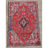 A GOOD QUALITY HANDKNOTTED PERSIAN SAROUK WOOL RUG, with red and blue main ground colours, with a