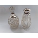 TWO EARLY 20TH CENTURY SILVER TOPPED CUT GLASS SCENT BOTTLES, (i) with a screw on silver top,