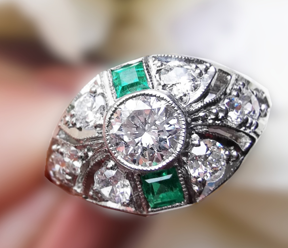 A BEAUTIFUL ART DECO PLATINUM EMERALD AND DIAMOND EYE SHAPED RING, with the finest of gemstones,