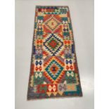 A DECORATIVE KELLIM RUNNER RUG, hand woven by a weaver from the Hazara Tribe of Central