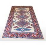 AN AFGHAN SHIRVAN RUG, Afghanistan, hand woven on a hand loom, featuring a geometric repeat