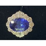 AN 18CT WHITE GOLD ART DECO STYLE TANZANITE AND DIAMOND CLUSTER RING, the superb oval shaped