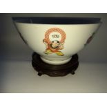 A MID CENTURY CHINESE RICE BOWL, decorated with figures of children, and flowers, with red maker’s