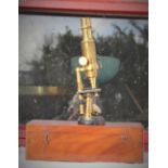 A LATE 19TH CENTURY BRASS MICROSCOPE, cased in original mahogany box, in good working condition.