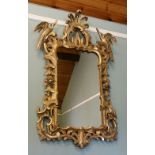 A FANTASTIC LARGE GILT WALL MIRROR, in the carved Chippendale style, decorated with Ho-Ho birds,