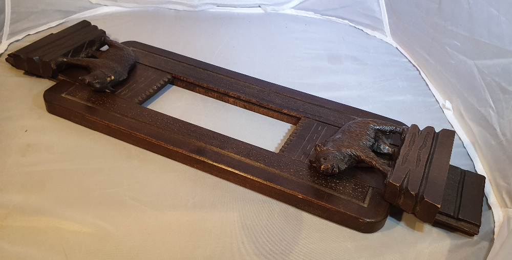 AN EARLY 20TH CENTURY CARVED BLACK FOREST TABLE TOP BOOKSLIDE, each collapsible end decorated with - Image 3 of 4