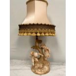 A PORCELAIN LAMP in the form of two children playing beneath a tree, comes with shade, stamp and