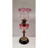 A FINE IRISH LATE 19TH / EARLY 20TH CENTURY OIL LAMP, with clear chimney, and cranberry-clear