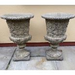 A PAIR OF STONE GARDEN URNS, 61cm tall approx.