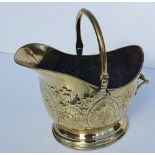 A GOOD QUALITY 19TH CENTURY EMBOSSED POLISHED BRASS COAL SCUTTLE, in excellent condition, 43.2cm (H)