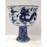 A LARGE BLUE AND WHITE DRAGON STEM CUP, with scalloped shape, the interior with an image of fruit