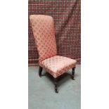 A VICTORIAN LOW / NURSING CHAIR, raised on turned front leg on castors, 108cm x 50cm x 50cm approx.