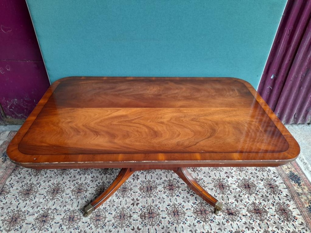 A COFFEE TABLE, with reeded edge, raised on 4 turned column support and down swept legs on