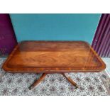 A COFFEE TABLE, with reeded edge, raised on 4 turned column support and down swept legs on