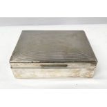 AN EARLY TO MID 20TH CENTURY SILVER CIGARETTE BOX, with wooden lining and engine cut decoration to