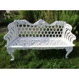 A GOOD WHITE CAST METAL GARDEN BENCH, decorated with floral and scroll detailing throughout the seat
