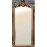 A RECTANGULAR GILTWOOD ELONGATED HALL MIRROR, with foliage motif to the mount and lower corners,
