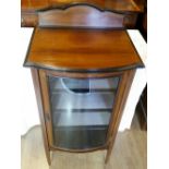 AN EDWARDIAN MAHOGANY AND INLAID BOW FRONTED GLAZED DISPLAY CABINET, circa 1900, the top with raised