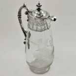 A LATE 19TH CENTURY SILVER AND GLASS CLARET / WINE JUG, the glass decorated with classical imagery