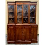 A VERY FINE MAHOGANY BREAKFRONT GLAZED BOOKCASE, with dentil moulded cornice, over four astragal