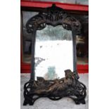 AN ART NOUVEAU STYLE METAL MIRROR, with reclining lady, the mirror glass is distressed with age,