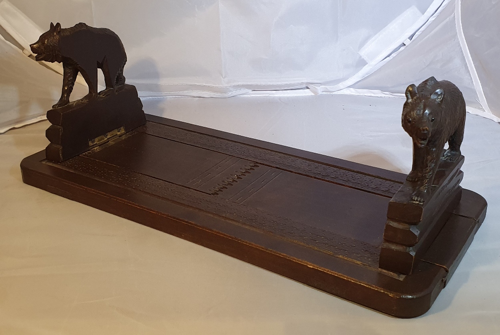 AN EARLY 20TH CENTURY CARVED BLACK FOREST TABLE TOP BOOKSLIDE, each collapsible end decorated with - Image 2 of 4