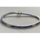 A STUNNING 18CT WHITE GOLD SAPPHIRE AND DIAMOND TENNIS BRACELET, with princess cut sapphires