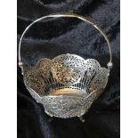 A FINE MID 20TH CENTURY SILVER BASKET, with swing handle, decorated with baskets of flowers and