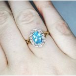 A 9CT YELLOW GOLD VINTAGE BLUE TOPAS AND DIAMOND CLUSTER RING, beautiful colour, ring size M. face