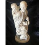 A CHINESE IVORY OKIMONO OF A FATHER WITH TWO PLAYFUL CHILDREN, circa 1890- 1920, carved from a