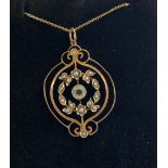 A 9CT YELLOW GOLD VINTAGE HAND-MADE CIRCULAR SWIRL PENDANT, with a centre aquamarine stone,