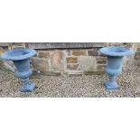 A GOOD QUALITY PAIR OF HEAVY CAST IRON GARDEN URNS, with classical gadrooned rim design, grey