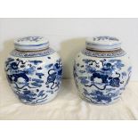 A PAIR OF BLUE AND WHITE CHINESE GINGER JARS, with lids, decorated with animals, 27cm tall approx.