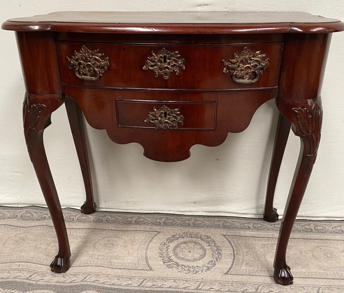 A VERY FINE REGENCY MAHOGANY LOW BOY, of nice neat proportions, with serpentine shaped top and sligh