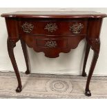 A VERY FINE REGENCY MAHOGANY LOW BOY, of nice neat proportions, with serpentine shaped top and sligh