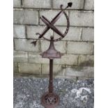 A GARDEN ORNAMENT OF A SUNDIAL / ARMILLARY, which sits upon a narrow column support which sits on a