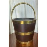 A MINIATURE BRASS BOUND BUCKET, with liner and a swing handle, size: 12 x 13 (H x W) approx in inche