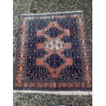 A PERSIAN FLOOR RUG, main ground blue with light orange colours, having multiple borders and three c