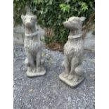 A PAIR OF COMPOSITE STONE ORNAMENTS in the form of sitting deer hounds with collars, size: 38 inches