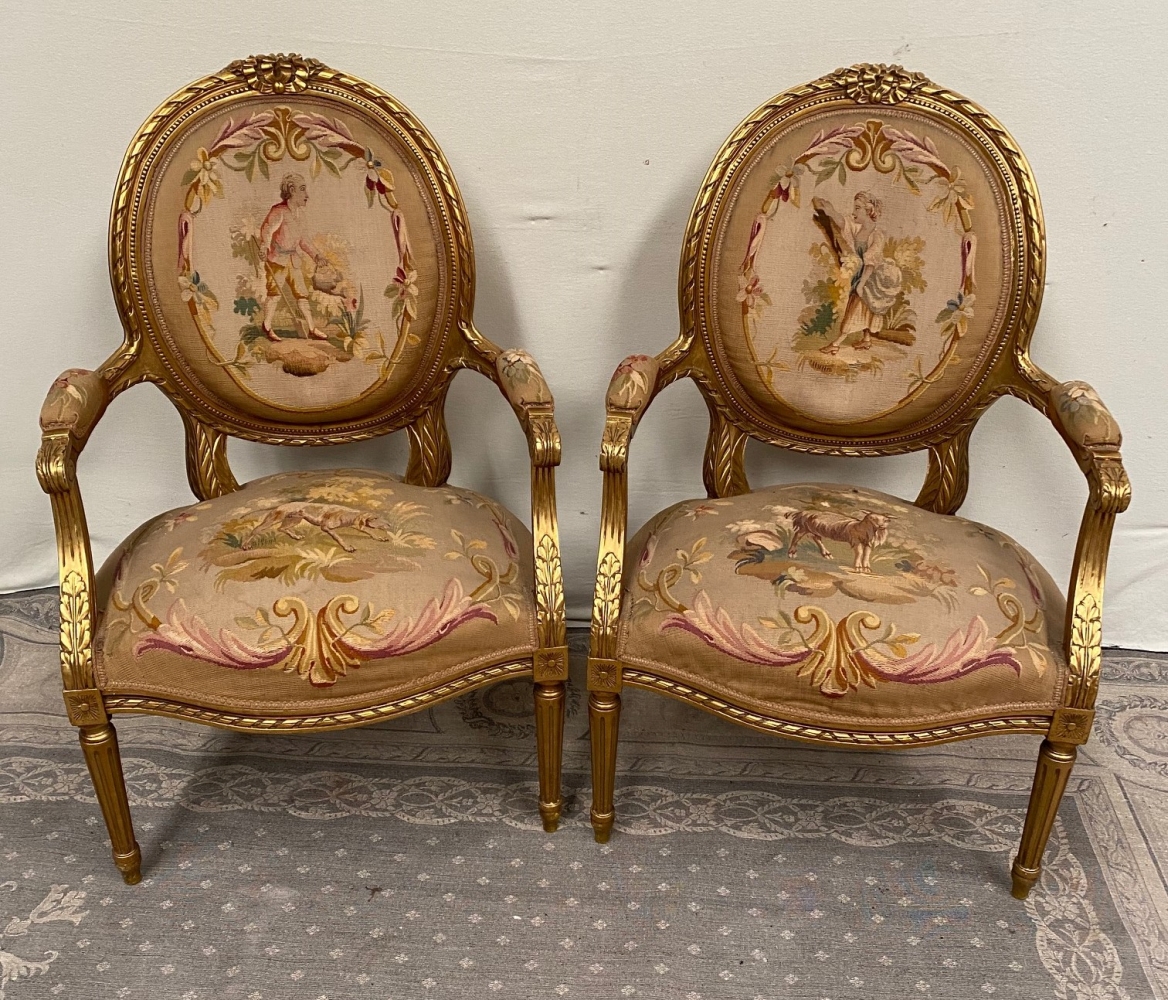 A PAIR OF GILT LOUIS XVI STYLE ARMCHAIRS with oval shaped back rests having ribbon detail to the edg