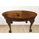 A MAHOGANY OVAL DINING TABLE, extendable, on cabriole leg, claw and ball feet, castor wheels, two le