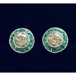 A FANTASTIC PAIR OF 18CT WHITE GOLD ART DECO STYLE DIAMOND AND EMERALD TARGET EARRINGS, with a centr