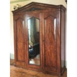 A LATE 19TH CENTURY THREE DOOR MAHOGANY GENTLEMAN’S WARDROBE, with mirror, panelled doors and engrav